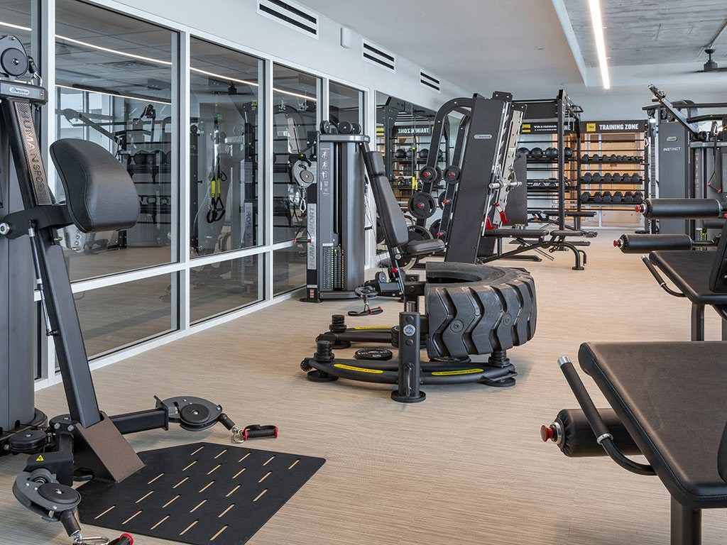 A gym with a variety of equipment including a leg press machine.