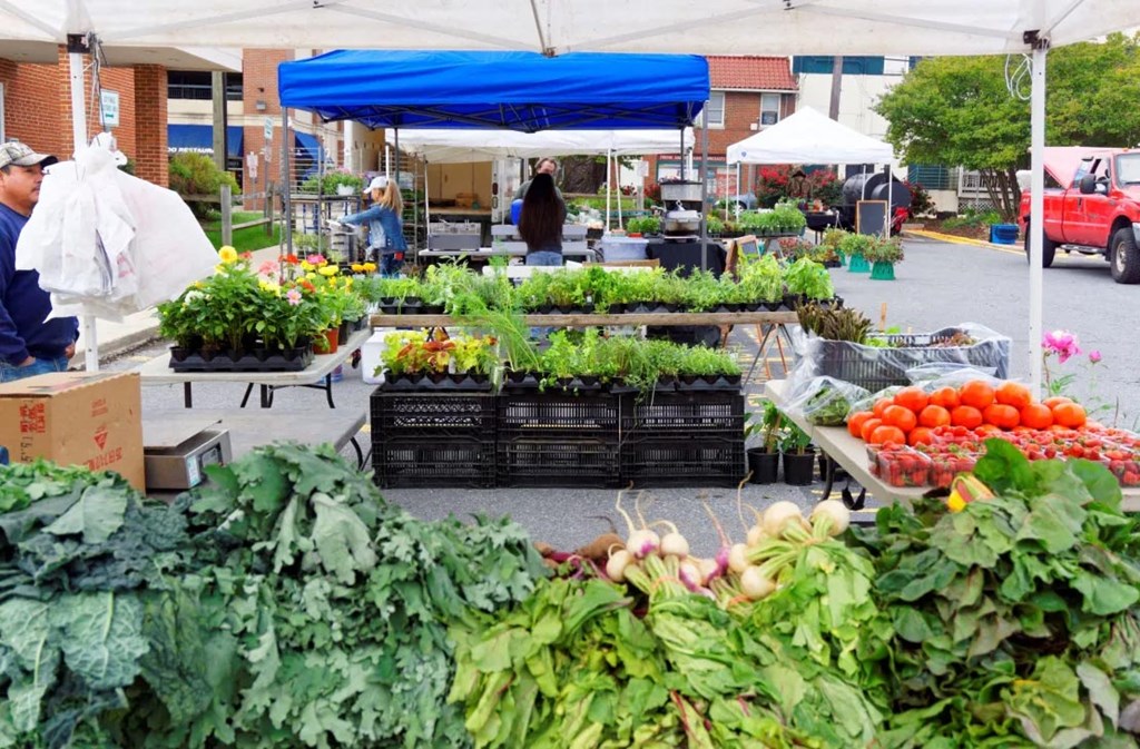 a farmers market filled with lots of fruits and vegetables