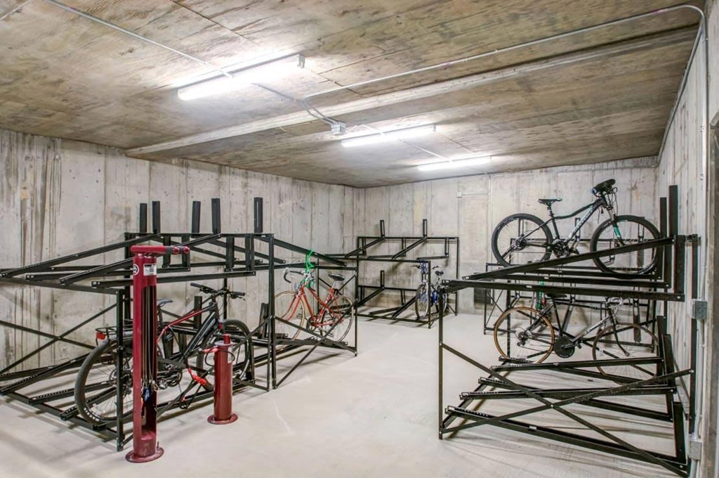a storage room with bikes on racks in it