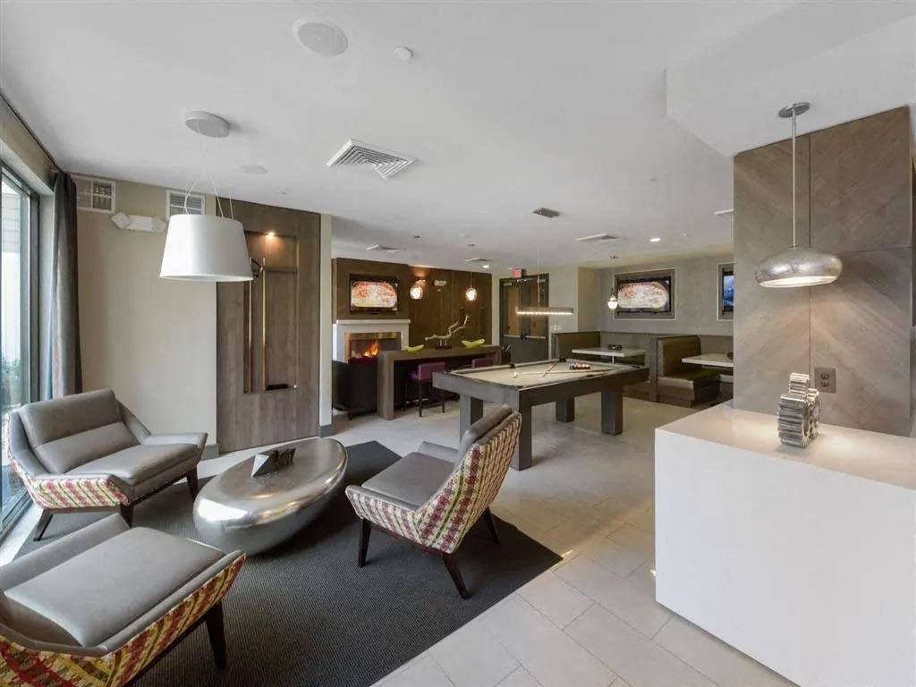 a living room and dining room with a table and chairs