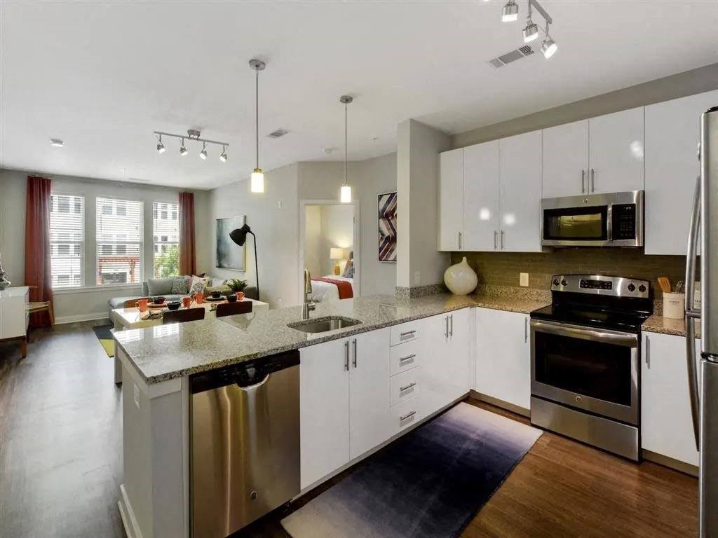a kitchen with stainless steel appliances and white cabinets