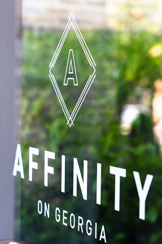 the logo for affinity on the front of a glass window