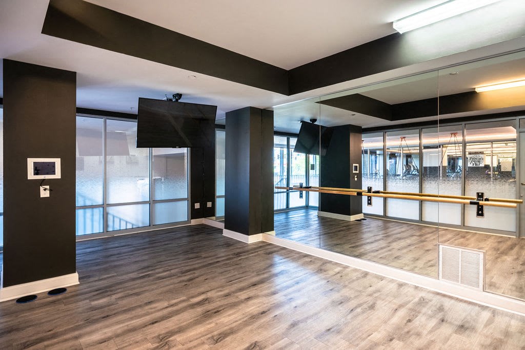 a large room with a wooden floor and glass doors