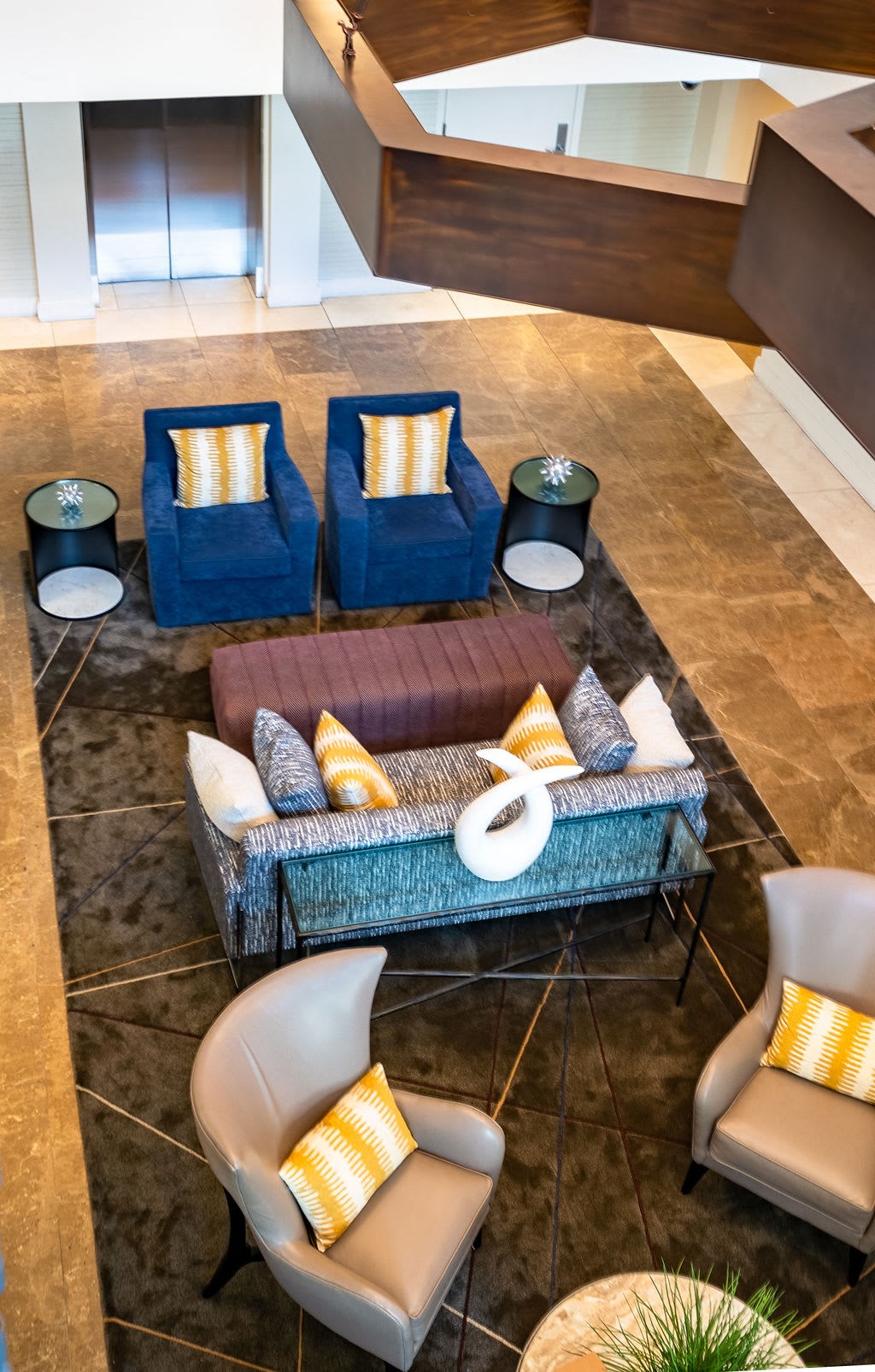 a seating area with couches and chairs in a lobby