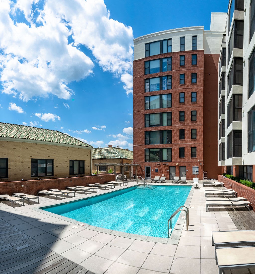 a swimming pool in the middle of two tall buildings