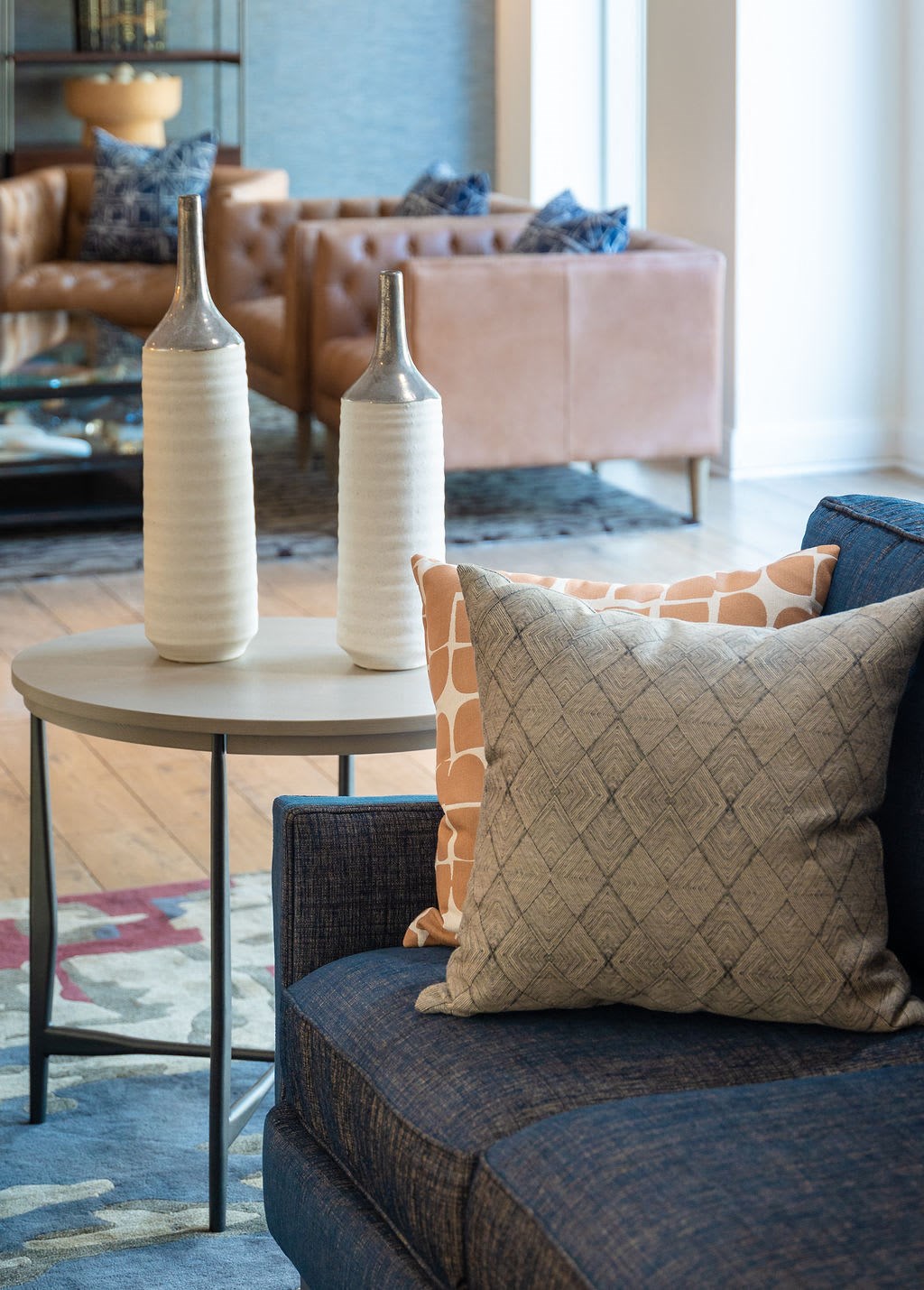 a living room with a couch and a table with vases on it