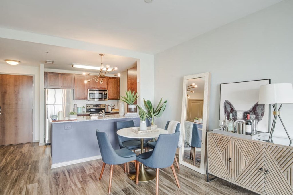 a dining room and kitchen with a table and chairs