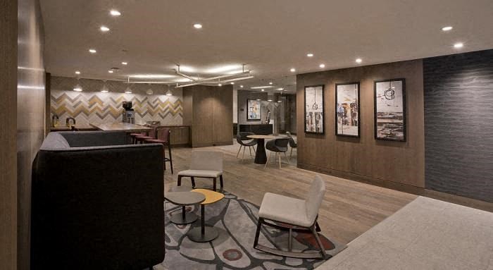 a hotel lobby with chairs and a bar