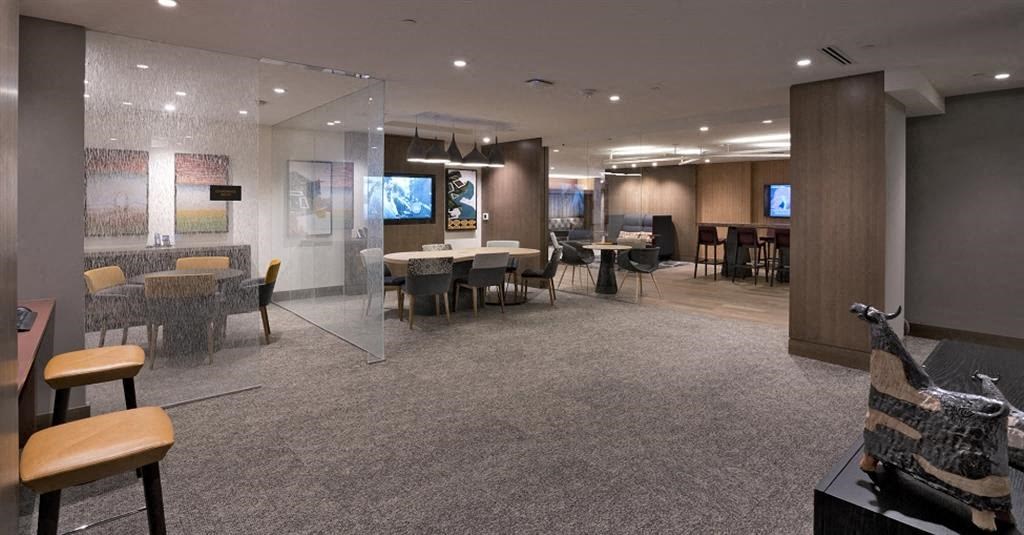 a large room with tables and chairs and a tv