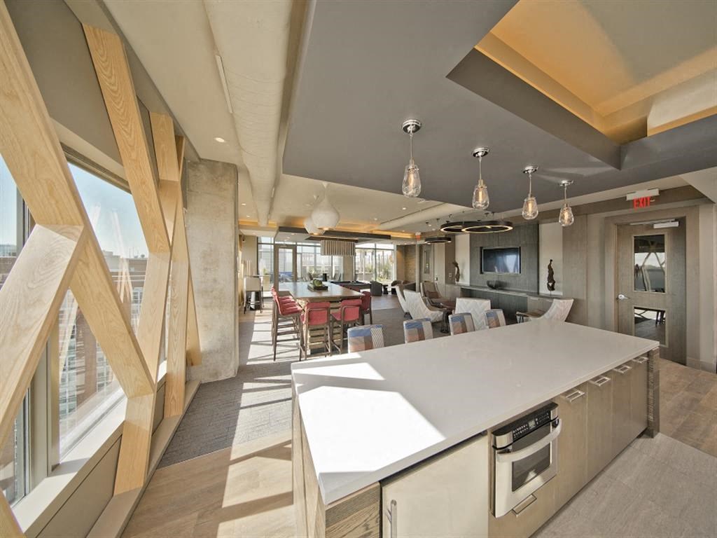 a large kitchen and dining area in a room with large windows