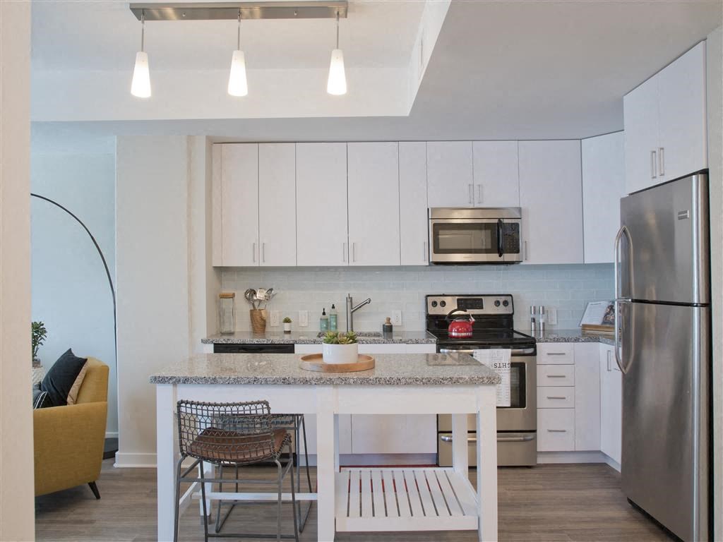 a kitchen with a counter top and a refrigerator