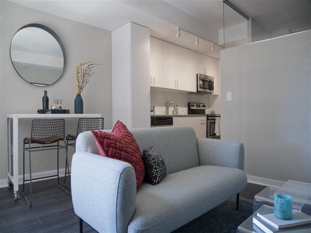 a living room with a couch and a kitchen in the background