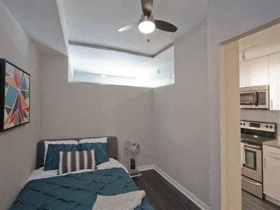 a bedroom with a bed and a ceiling fan