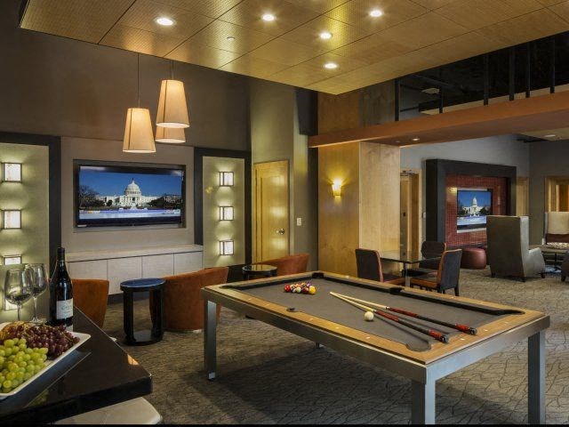 a game room with a pool table and a television