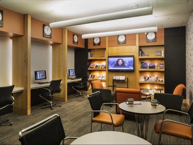 a room with tables and chairs and a television in it