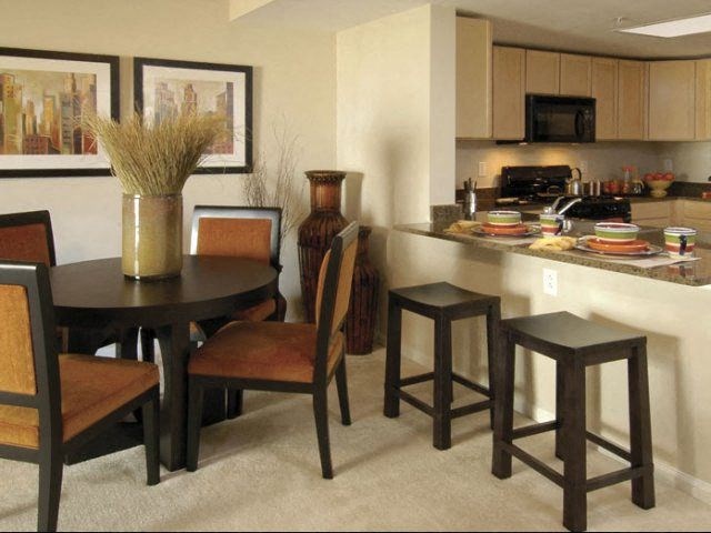 a kitchen and dining area with a table and chairs
