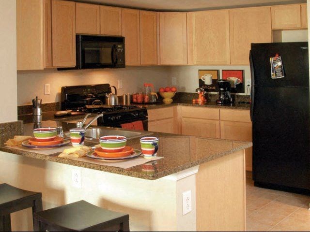a kitchen with a counter with plates on it