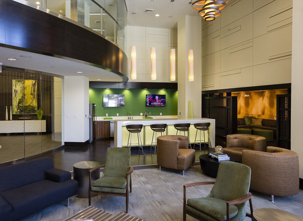 a lobby with a bar and couches and chairs