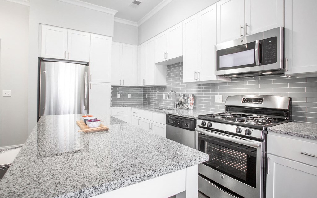 a kitchen with granite counter tops and stainless steel appliances