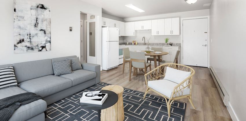 Living room with a view of the kitchen with hardwood flooring
