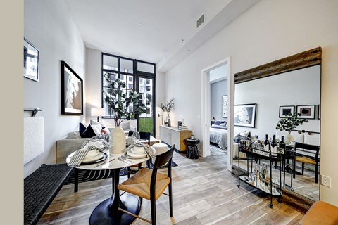living area with small dining table bar cart and sofa