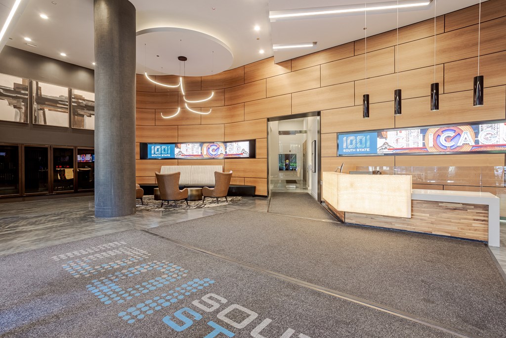 A lobby area with a large carpet that says "STOP" on it.
