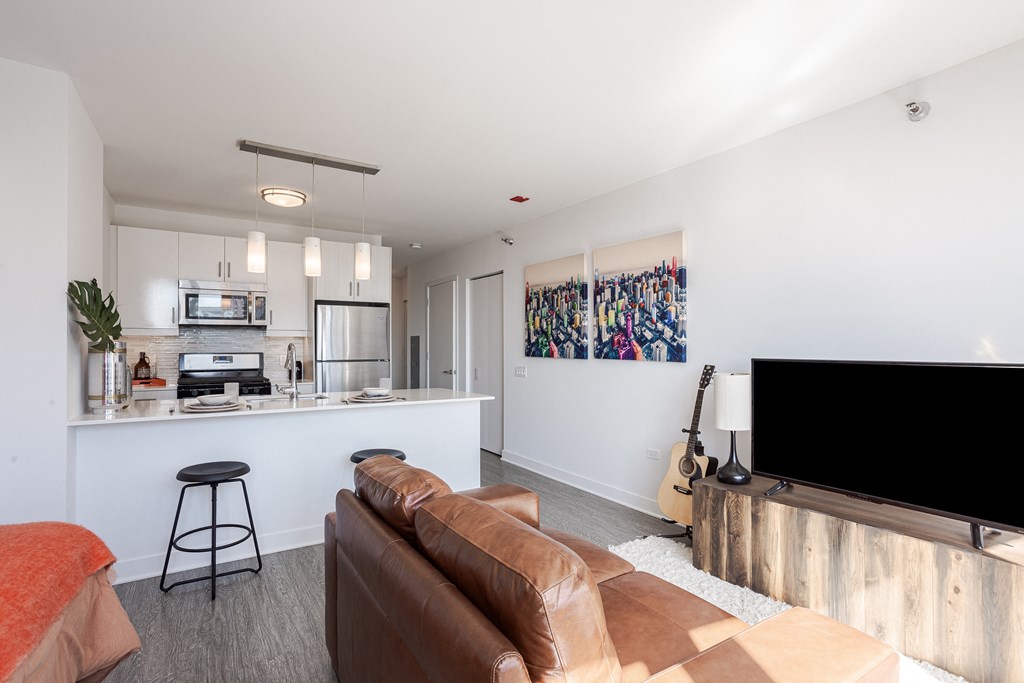 A living room with a brown couch and a television.