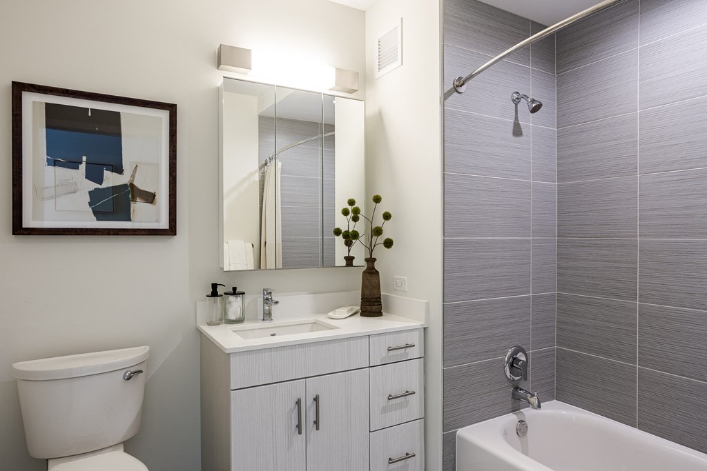 A bathroom with a white toilet, a white sink, and a white bathtub.