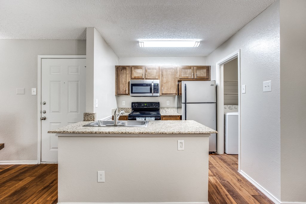 a kitchen with a counter top and a refrigerator