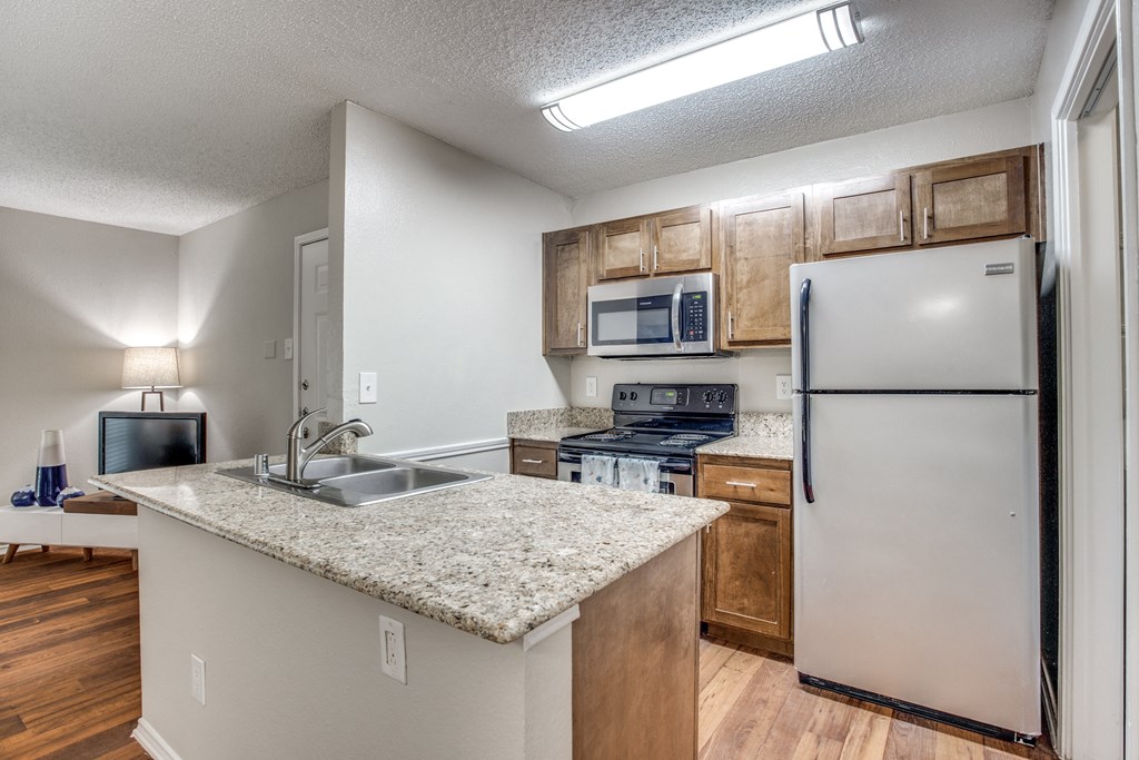 Granite countertops, stainless steel appliances, and wood cabinetry.
