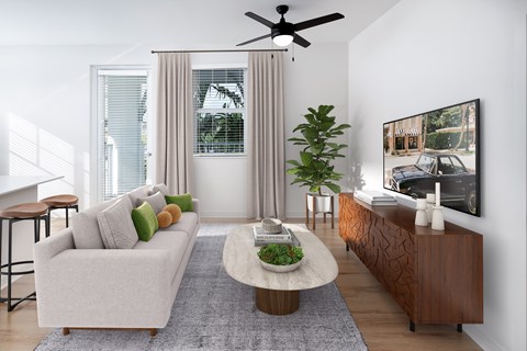A living room with a white couch, a coffee table, and a painting on the wall.