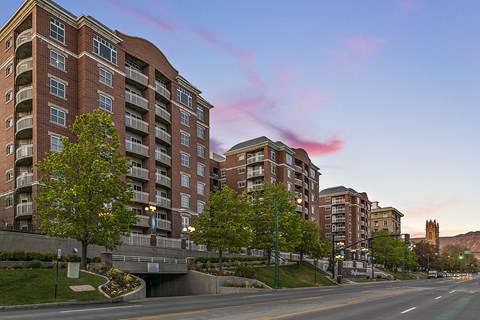 A large brick building with a bridge over a road.