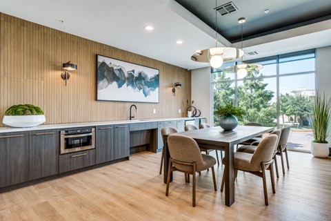 a kitchen and dining room with a table and chairs