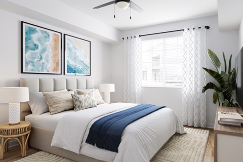 A bedroom with a large bed and a ceiling fan.