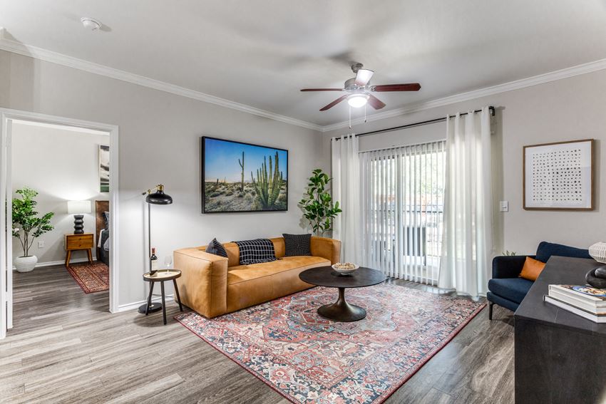 a living room with a couch and a ceiling fan