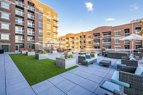 A sunny day at a modern apartment complex with a spacious courtyard.