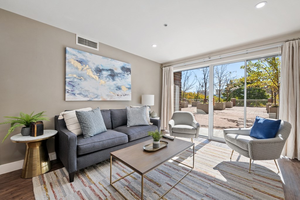 Furnished living room with plank style flooring, patio entrance