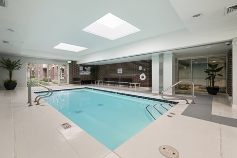 A large indoor swimming pool with a skylight above it.