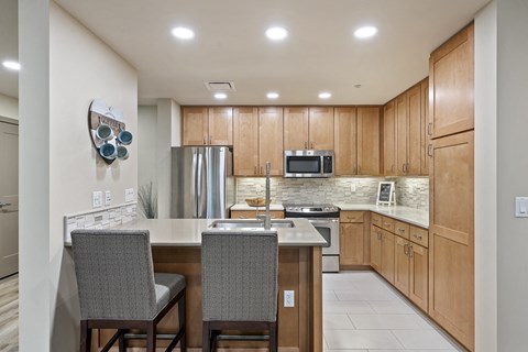 A kitchen with wooden cabinets and a white countertop.