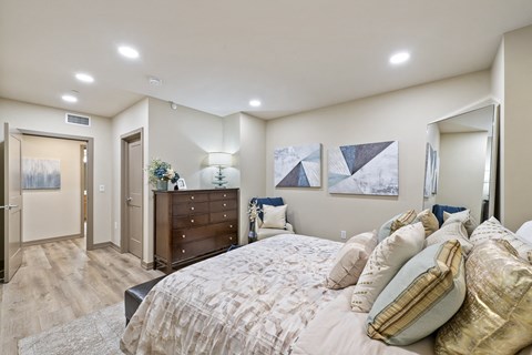 a bedroom with a large bed and a dresser