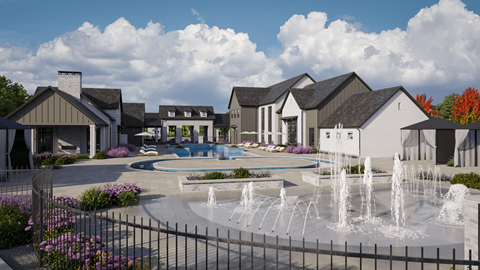 A fountain in front of a building with a sign that says "BARN".