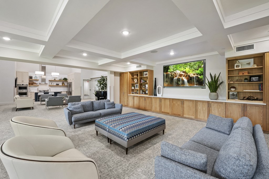 a living room filled with furniture and a large window