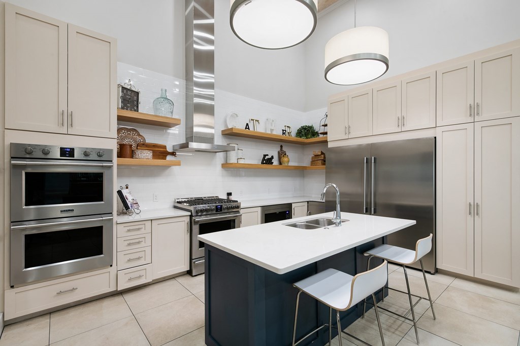 A modern kitchen with a large island and stainless steel appliances.