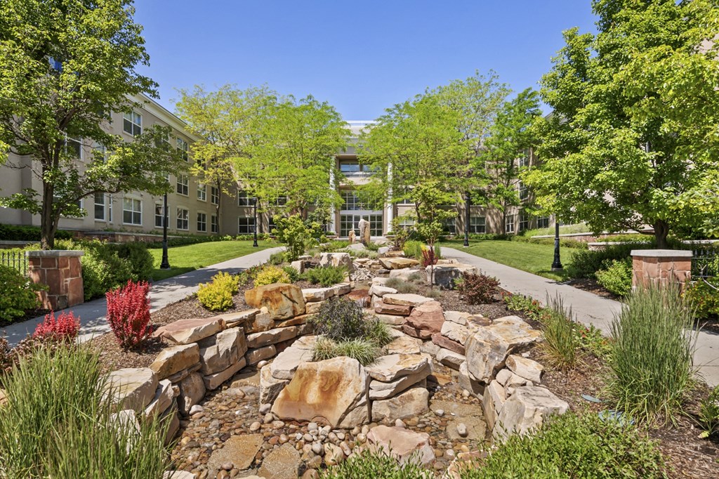 a large rock garden in front of an apartment building
