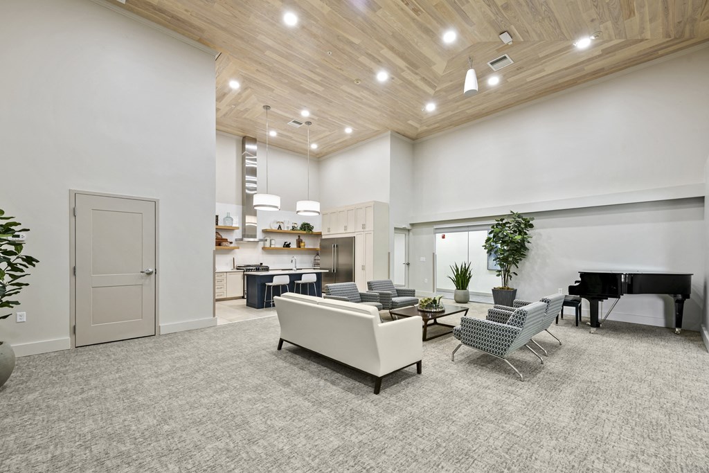 a living room filled with furniture and a piano