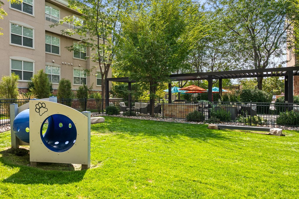 A playground with a slide and a ball.