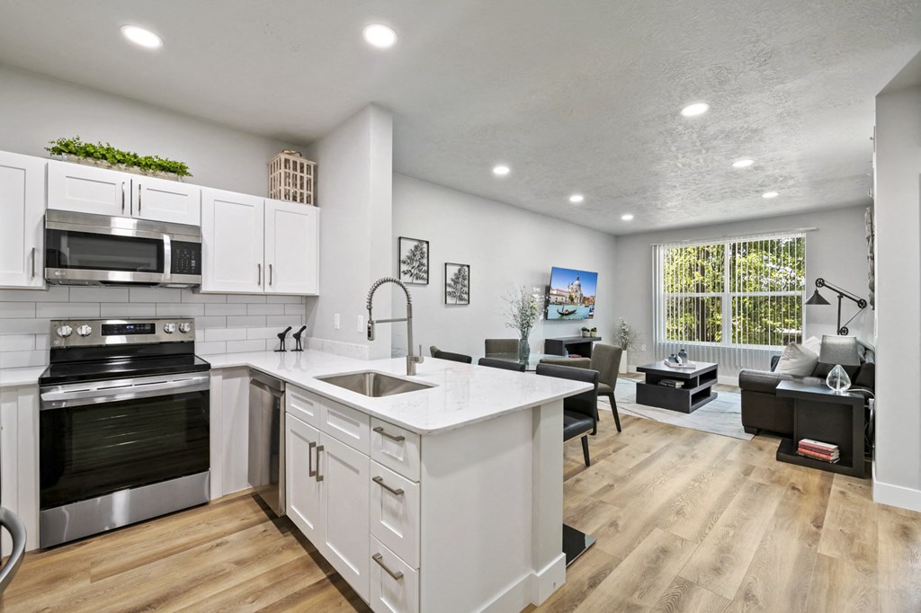 a kitchen and living room with a large window