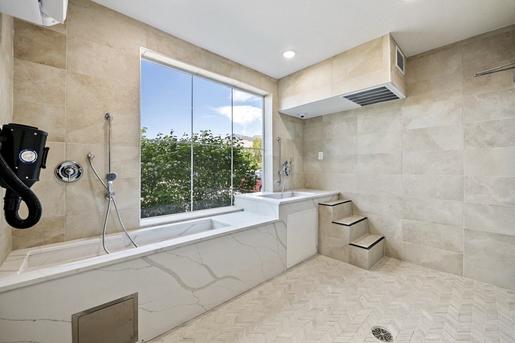 a bathroom with a large window and a bathtub