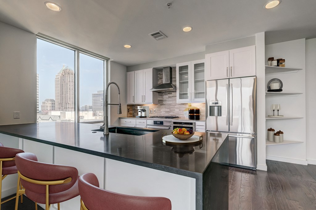 an open kitchen with a large island and a large window