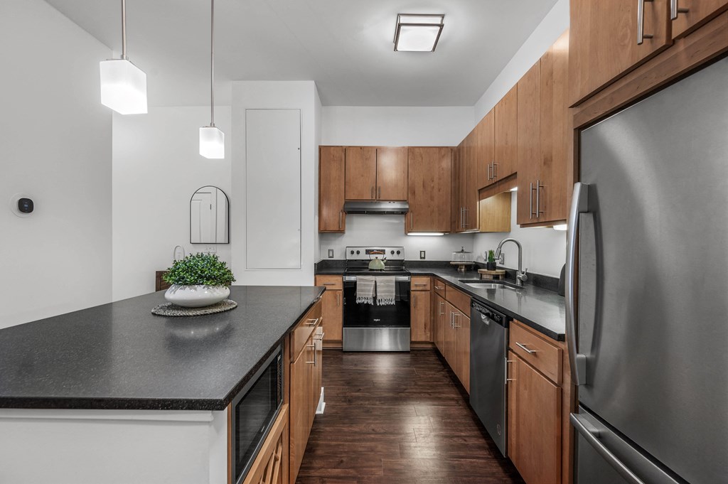 an expansive kitchen with stainless steel appliances and wooden cabinets